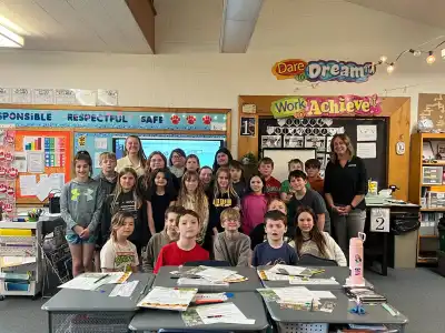 Image of a volunteer with group of students